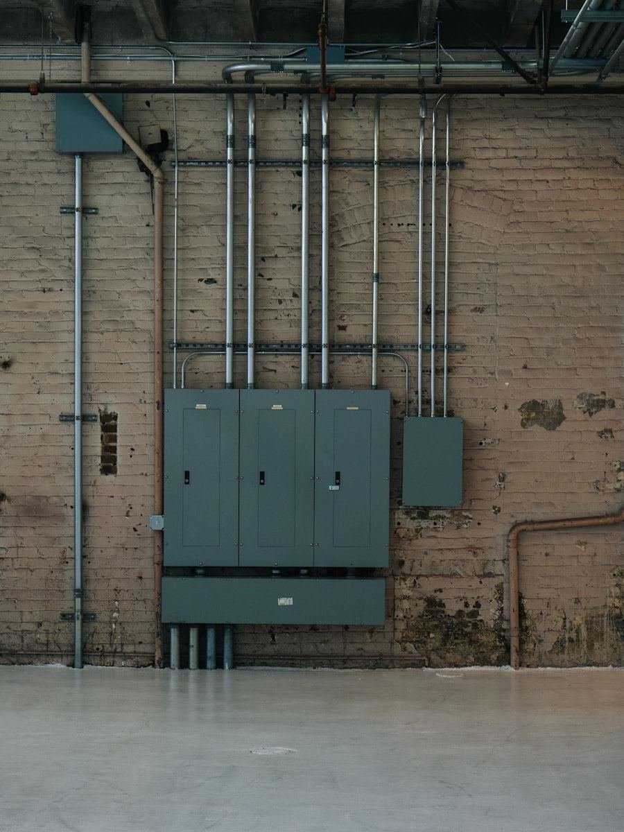 Conduit running down a commercial wall into a wall mounted distribution board.